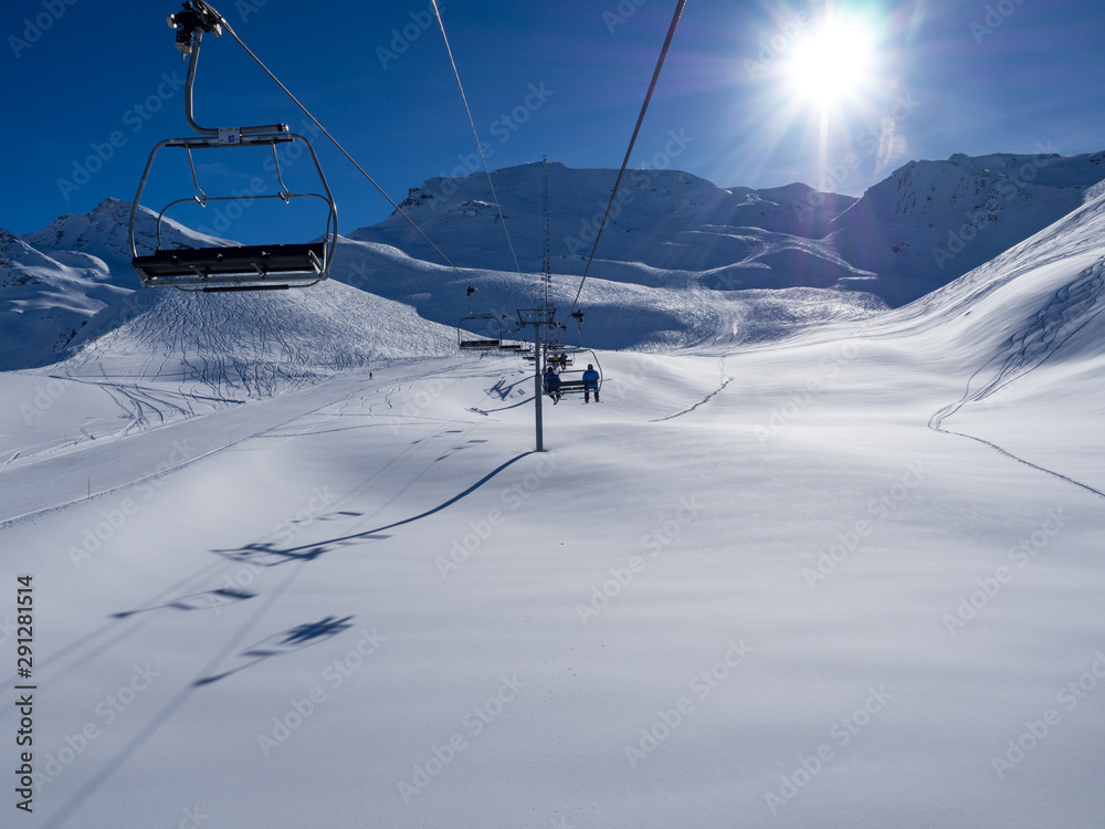 France, february 2019: Panoramic view of a snow covered alpine mountain range with chairlift ski lif