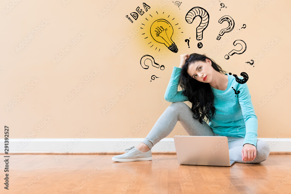 Idea light bulbs with question marks with young woman using a laptop computer