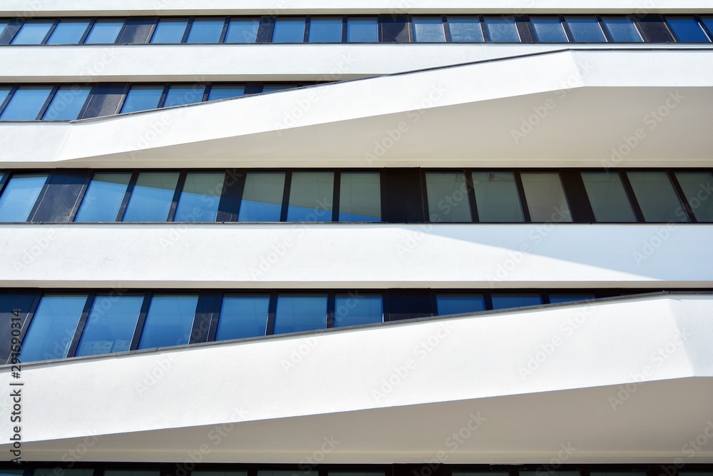 Facade fragment of a modern office building. Exterior of glass wall with abstract texture.