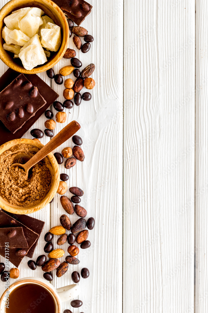 Cook homemade chocolate with bars, nuts, coffee beans on white wooden background top view mock up