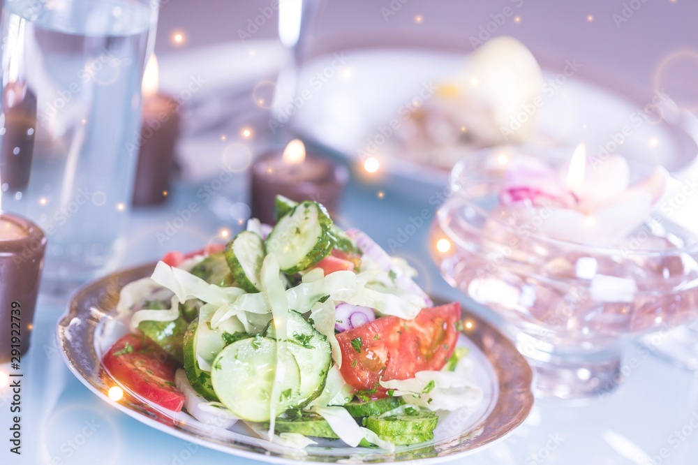 Close-up of Table with Food, Plates, Candles and Champagne Flutes