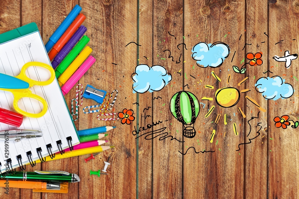 Colorful school supplies on wooden table background