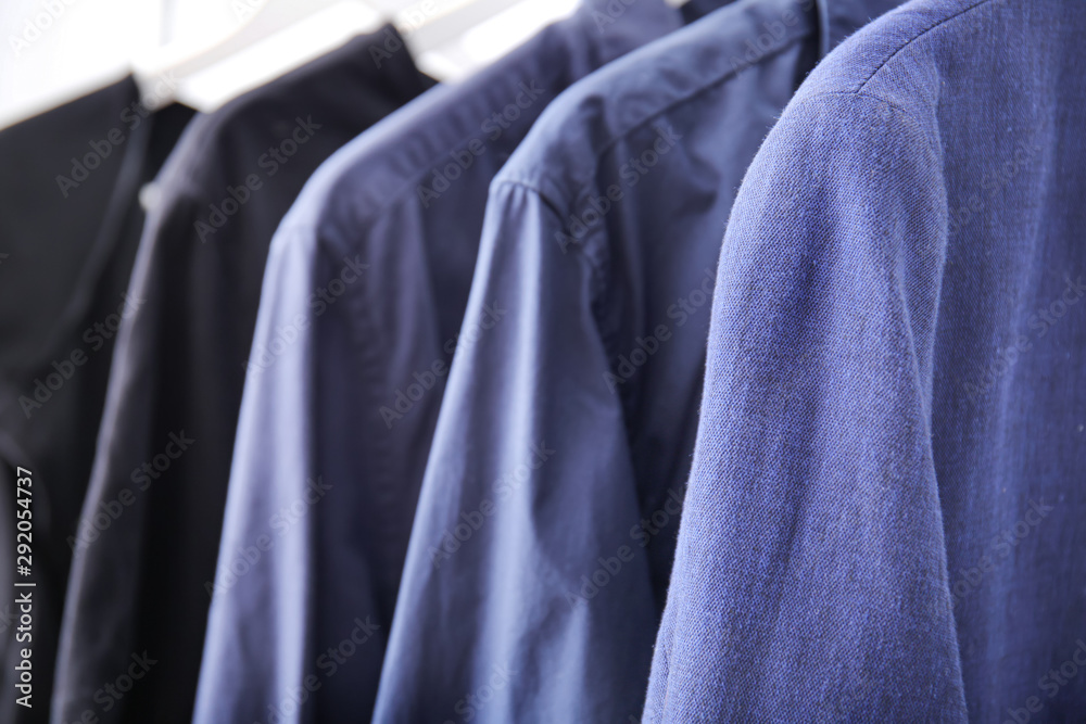 Hangers with stylish clothes, closeup