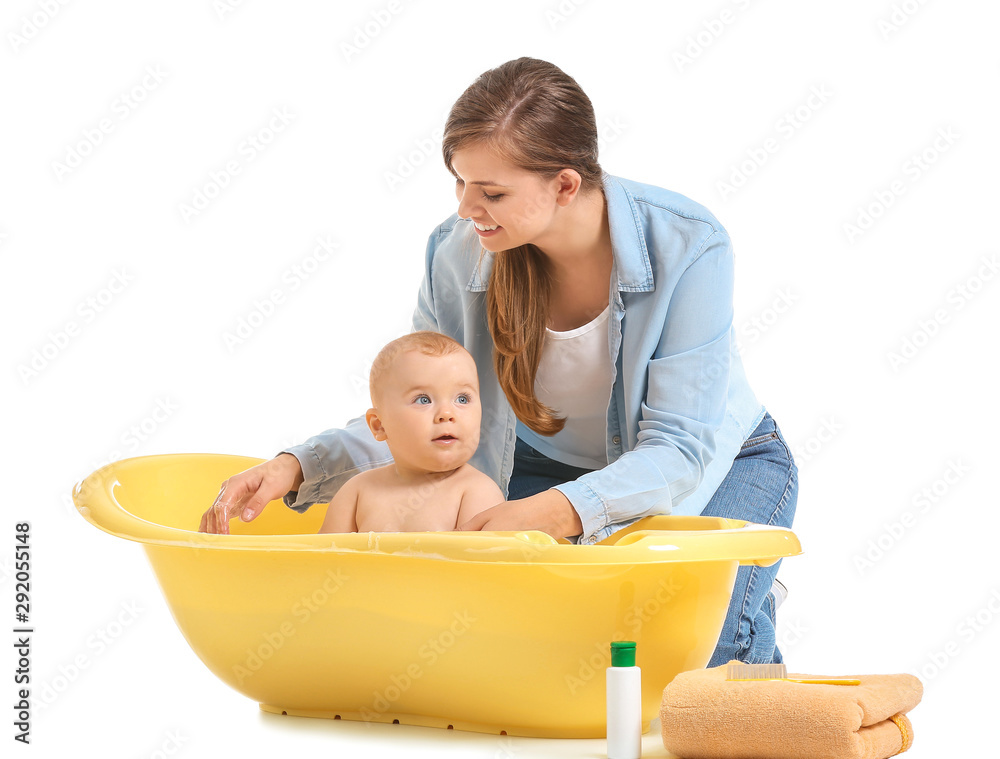 Mother bathing her cute little baby on white background