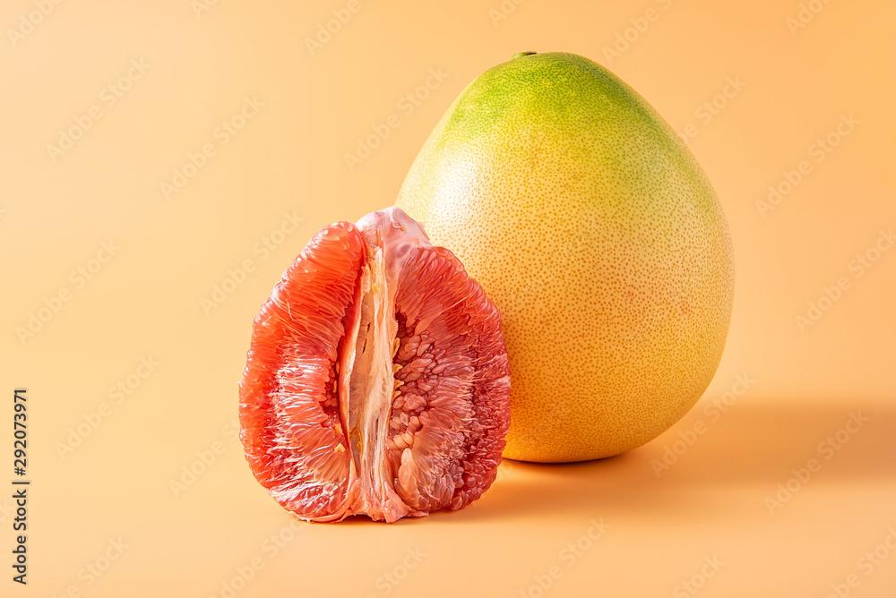 Big grapefruit and red flesh on yellow background