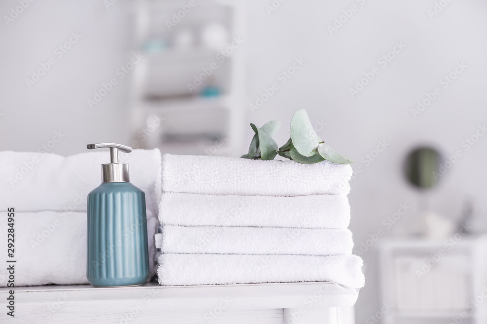 Soft clean towels with soap on table in bathroom