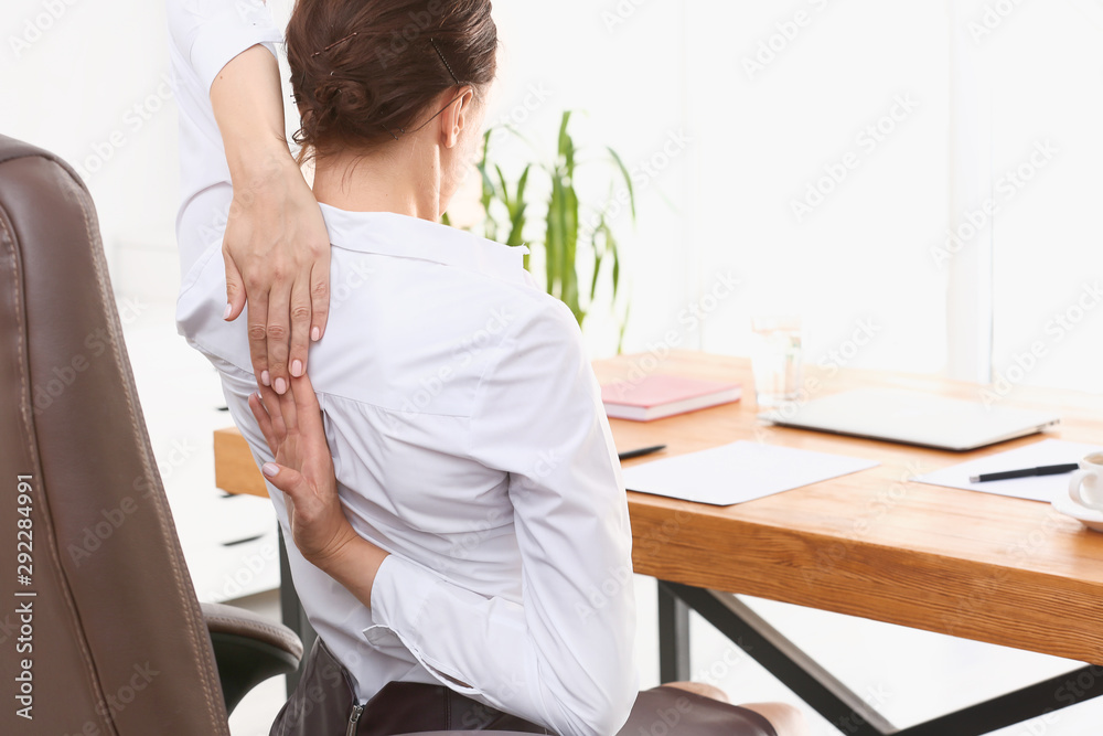 Young businesswoman practicing yoga in office