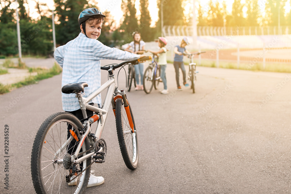 Cute children riding bicycles outdoors