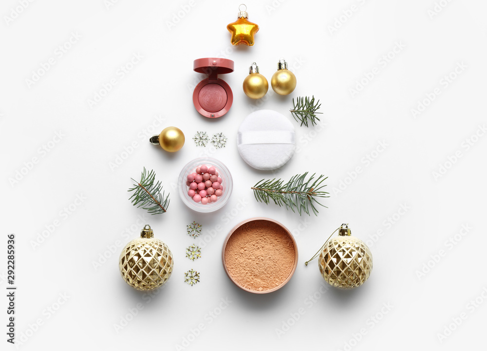 Christmas composition with decorative cosmetics on white background