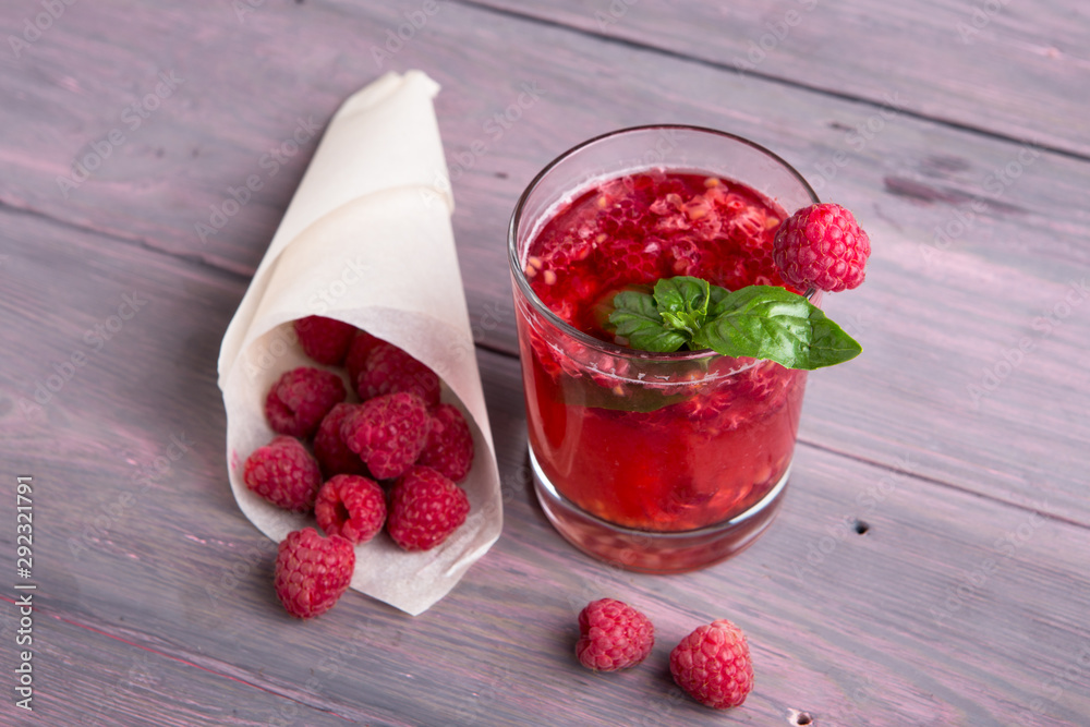 Glass of fresh strawberry smoothie and fresh strawberries on pink wooden background. Healthy food an