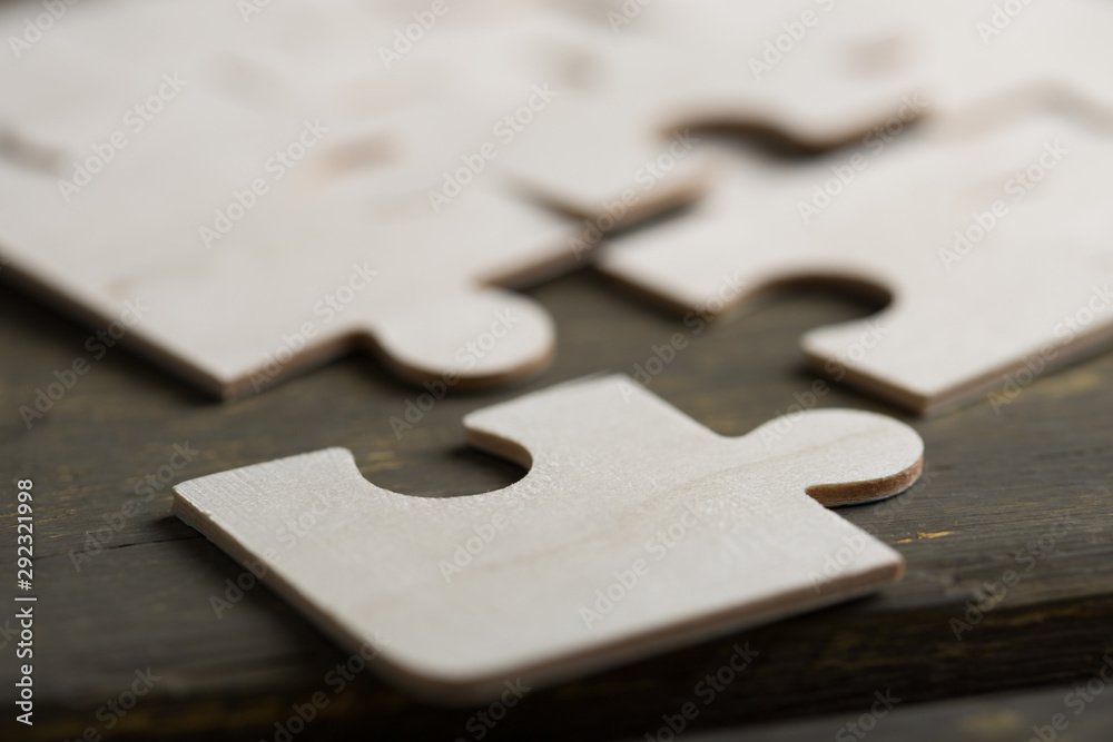 Creative solution for idea - business concept, jigsaw puzzle on the wooden desk