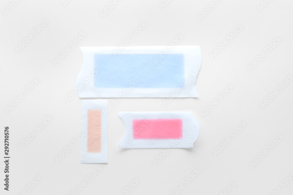 Wax strips for hair removal on white background