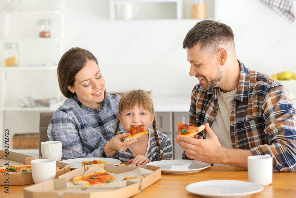 Happy family eating pizza at home