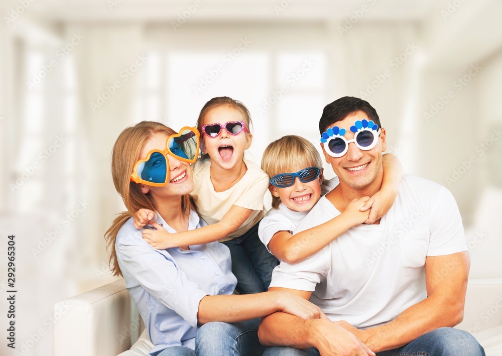 Beautiful smiling family in room on couch