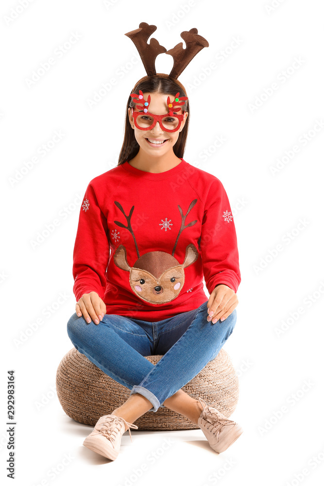 Funny young woman in Christmas sweater on white background