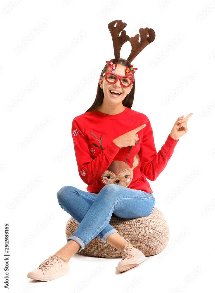 Funny young woman in Christmas sweater on white background