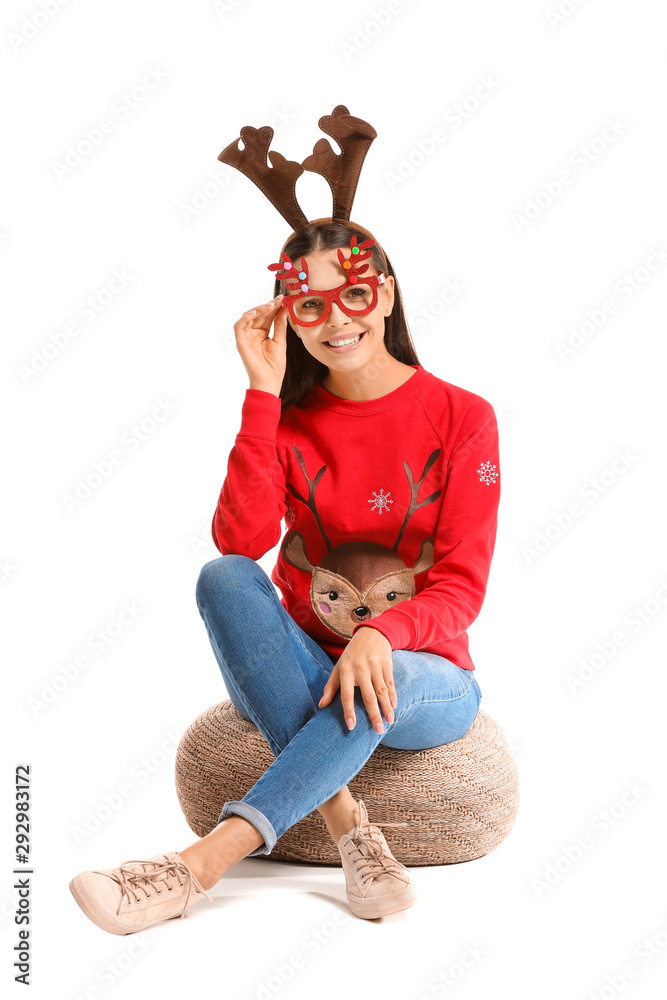 Funny young woman in Christmas sweater on white background