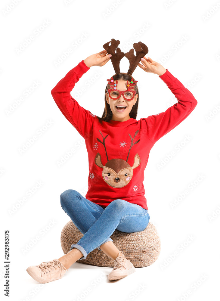 Funny young woman in Christmas sweater on white background