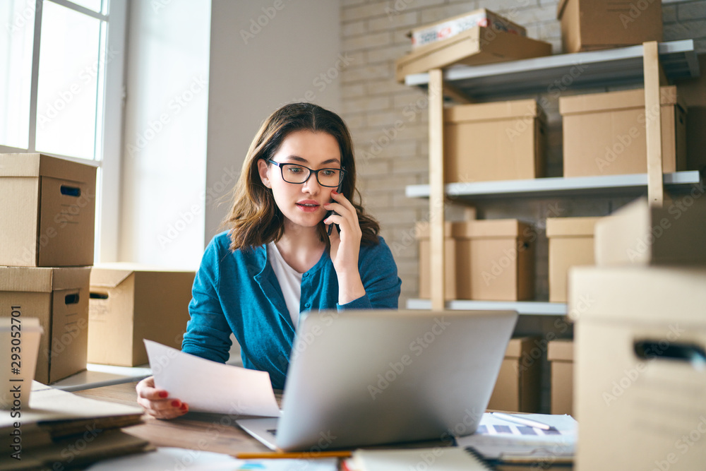 Woman is working at warehouse for online store.