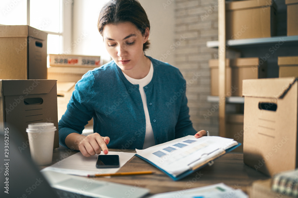 Woman is working at warehouse for online store.