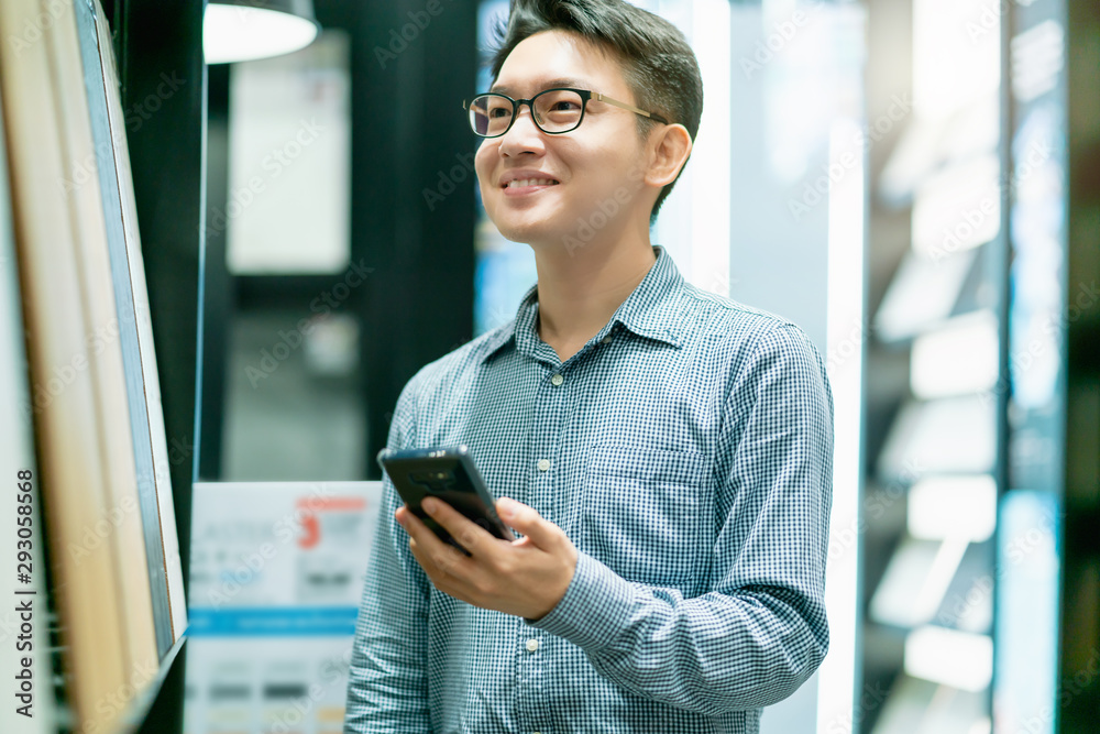 asian smart male designer happiness choosing material for design project