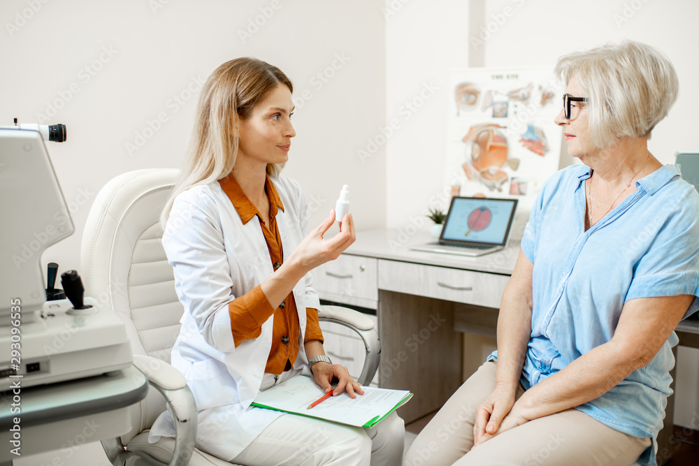 Senior woman patient talking with female ophthalmologist during a medical consultation at the ophtha