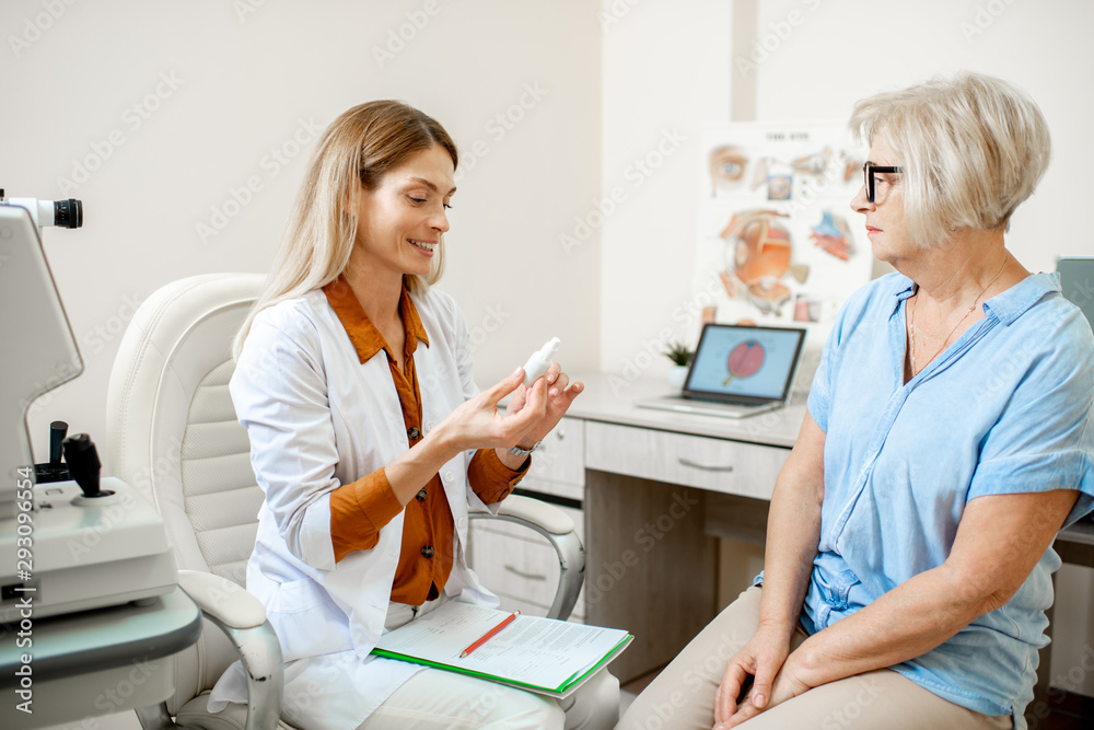 Senior woman patient talking with female ophthalmologist during a medical consultation at the ophtha