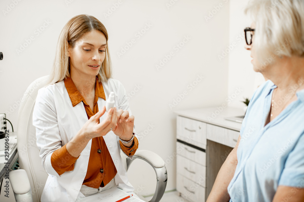 Senior woman patient talking with female ophthalmologist during a medical consultation at the ophtha