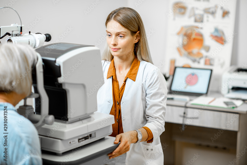 Ophthalmologist examining eyes of a senior patient using digital microscope during a medical examina