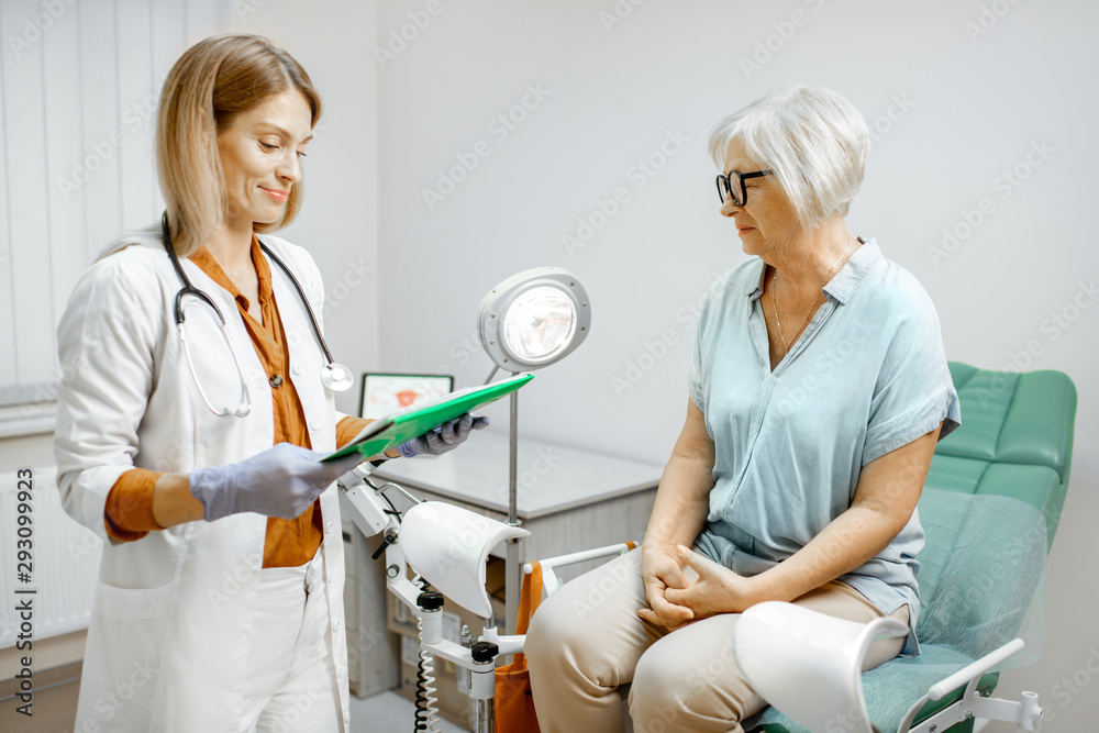 Senior woman sitting on the gynecological chair during a medical consultation with gynecologist. Con