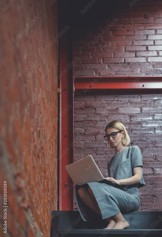 Attractive young girl with a laptop indoors