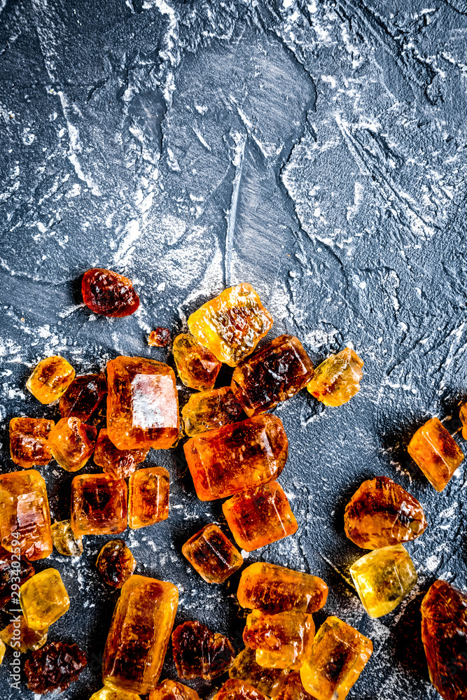 lumps of brown sugar for sweets on kitchen table background top view mock up