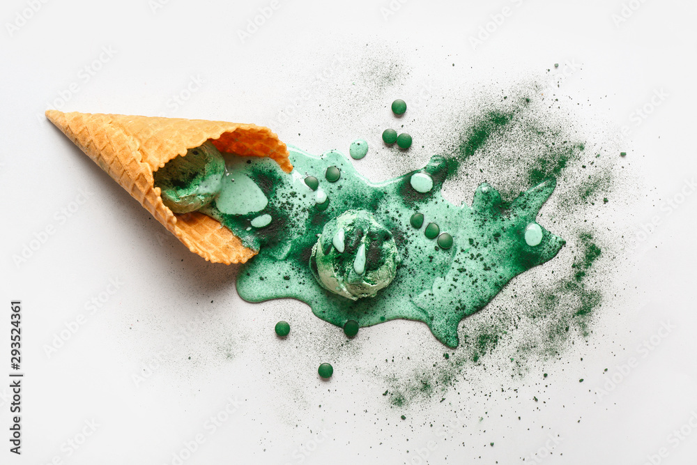 Waffle cone with tasty spirulina ice-cream on table