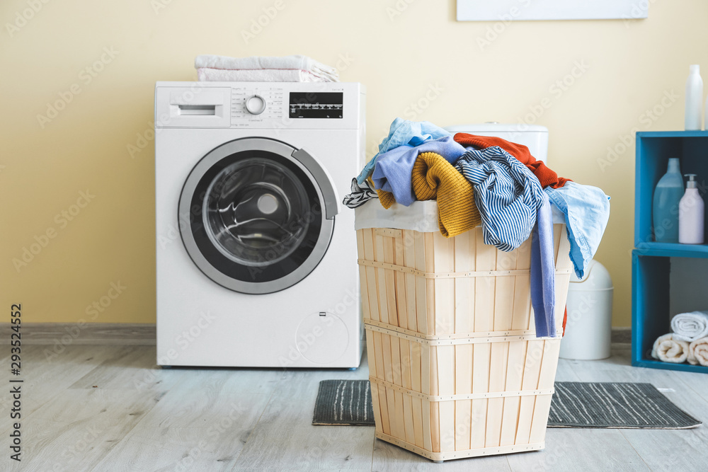 Basket with laundry in bathroom