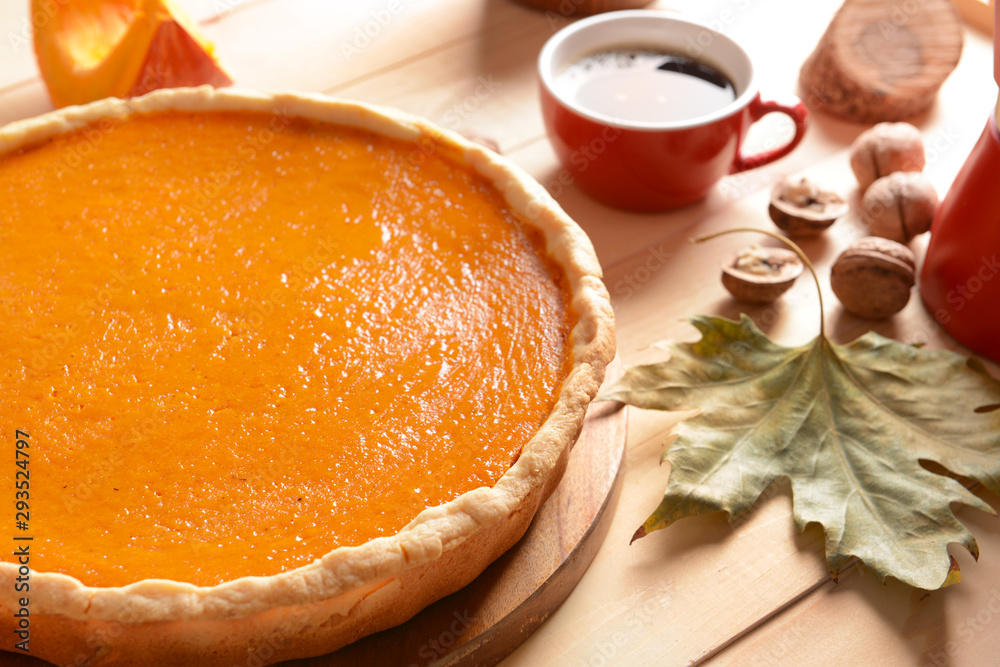 Tasty pumpkin pie on wooden table, closeup