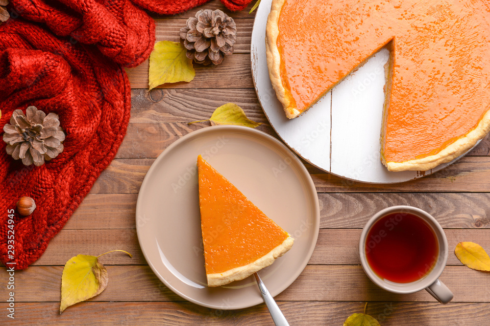 Composition with tasty pumpkin pie on wooden table