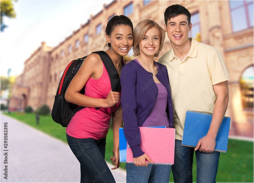 Group of graduated students with diploma on background