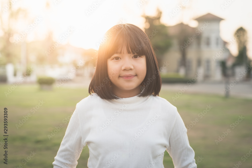 Portrait of cute asian girl outdoor under sunlight