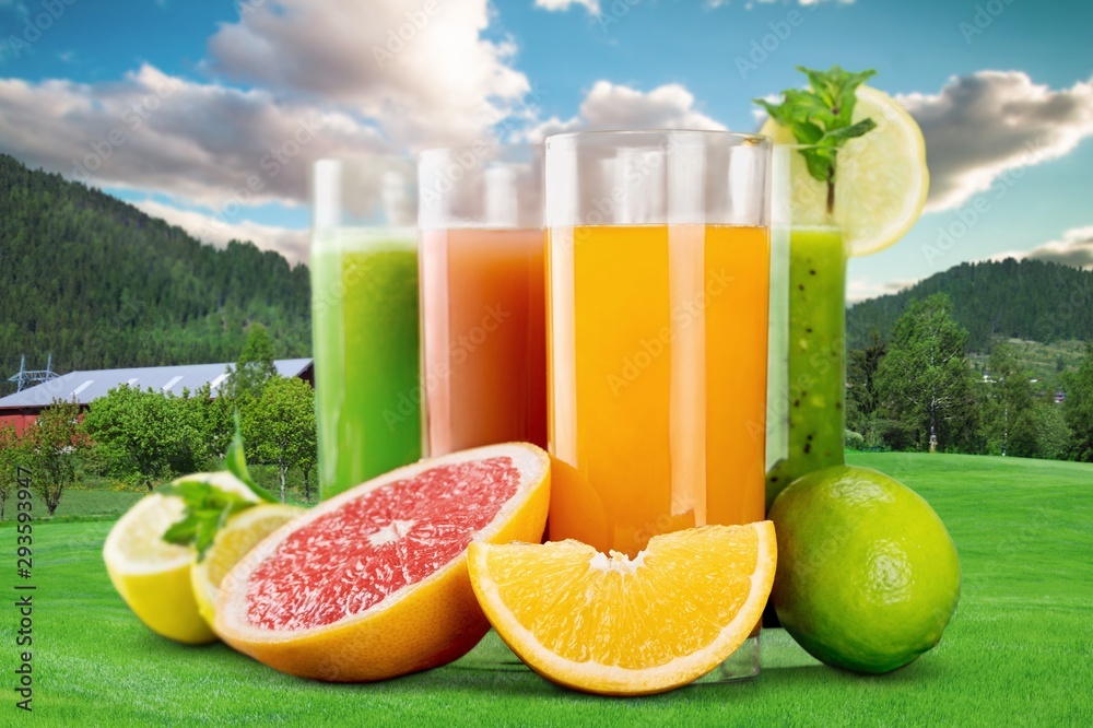 Tasty fruits  and juice with vitamins on background