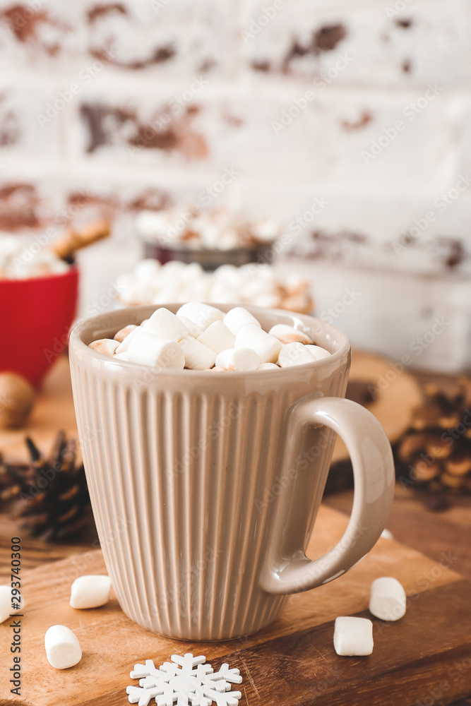 Cup of hot chocolate with marshmallows on table