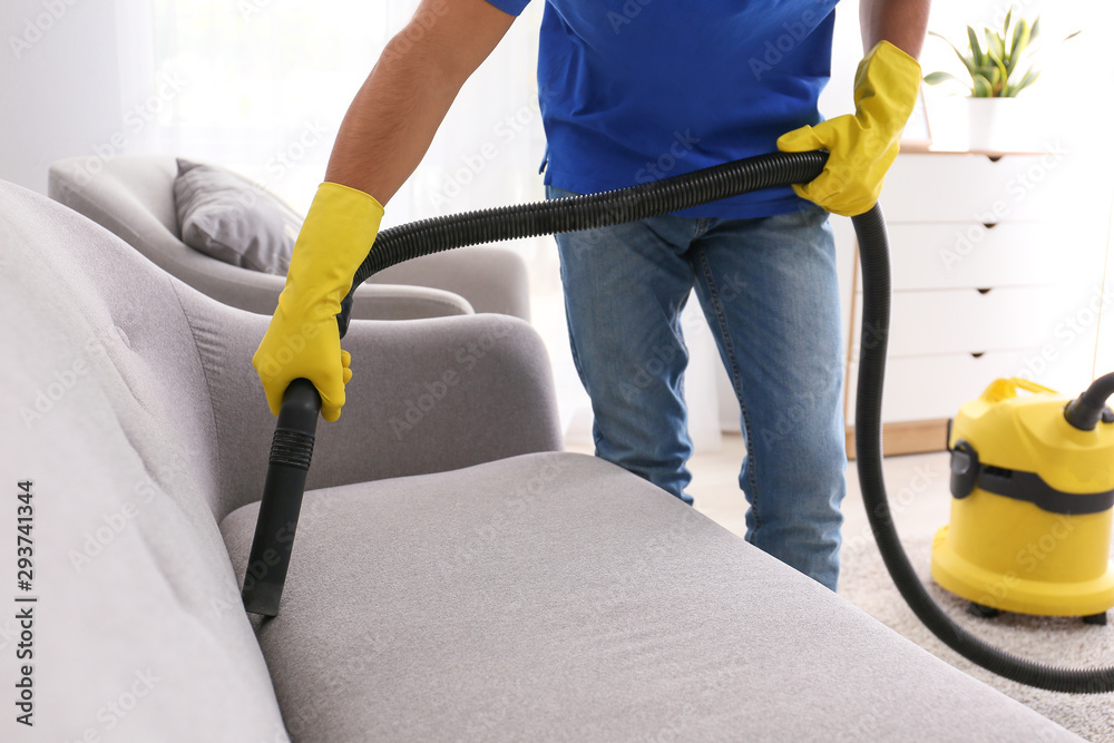 Young man cleaning his flat