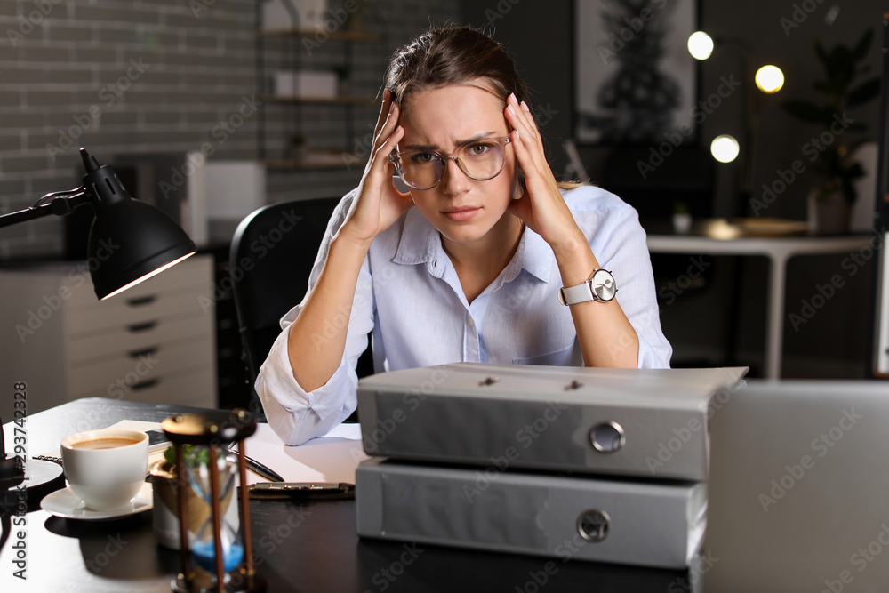 Tired businesswoman trying to meet deadline in office