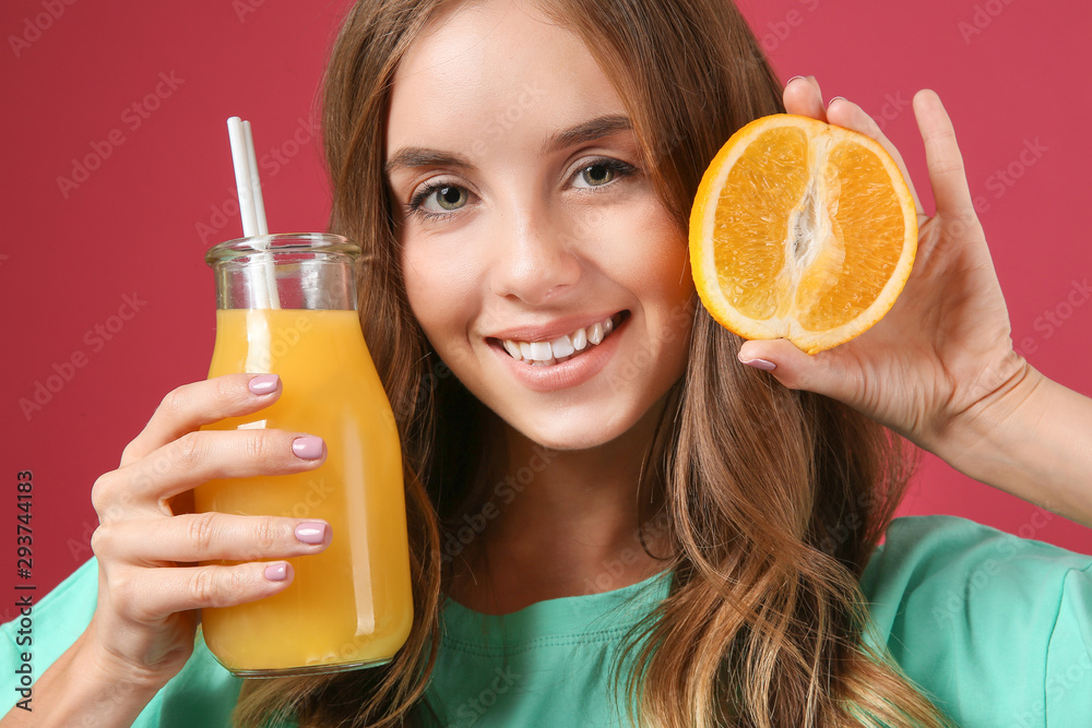 Beautiful young woman with orange juice on color background