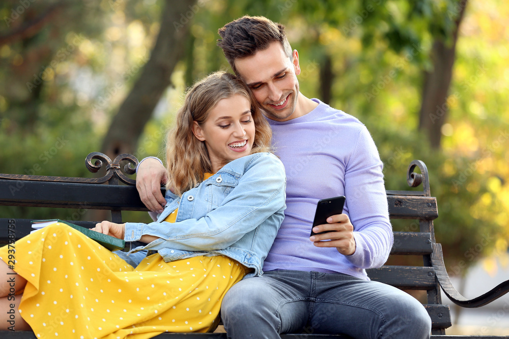 Happy young couple on romantic date in park