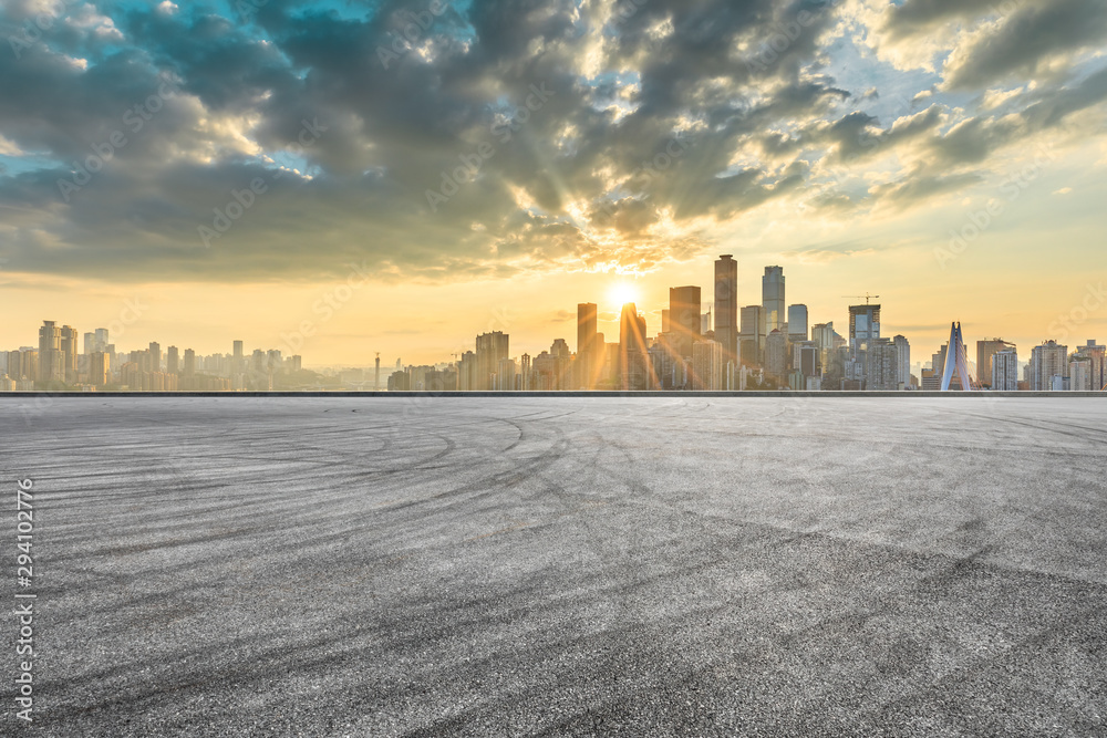 Empty race track ground and city financial district with buildings in Chongqing at sunset,China.