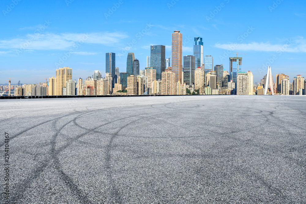 Empty race track ground and city financial district with buildings in Chongqing,China.