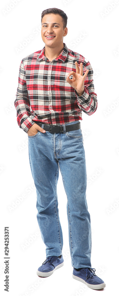 Portrait of handsome young man showing OK on white background