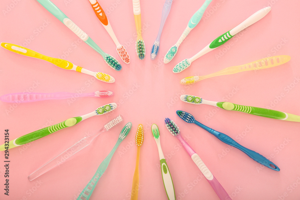 Many different tooth brushes on color background