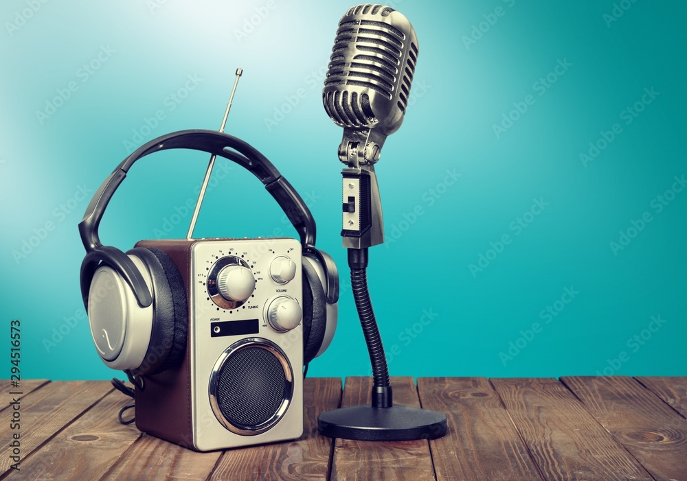 Retro style microphone and headphones on  background