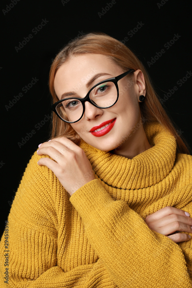 Portrait of beautiful young woman on dark background